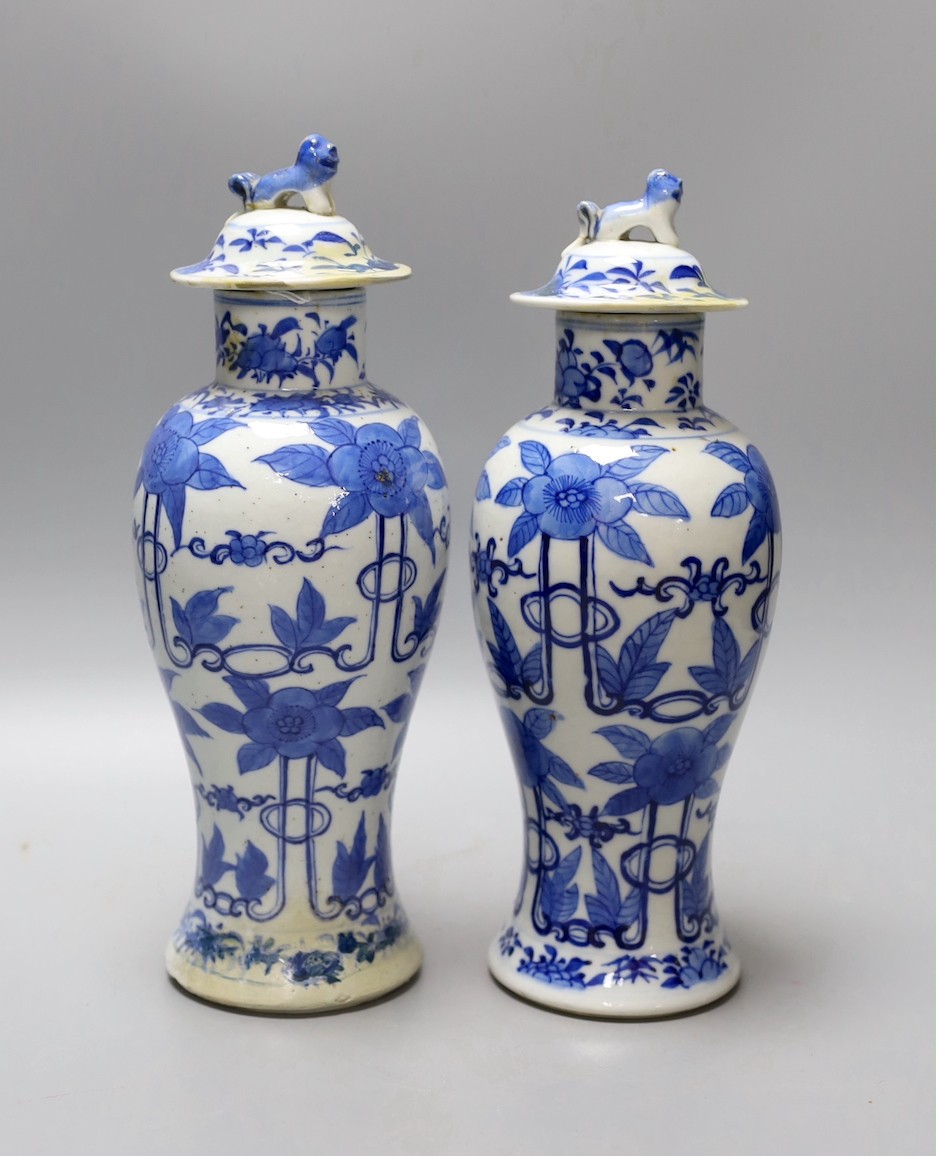 A pair of 19th century Chinese blue and white baluster jars and covers, 27cm